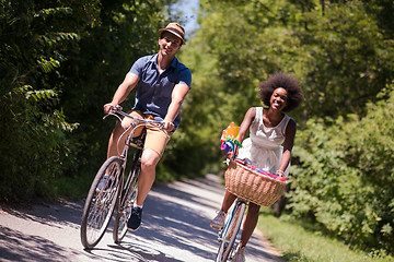 Image showing Young multiethnic couple having a bike ride in nature