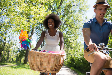 Image showing Young multiethnic couple having a bike ride in nature