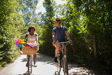 Image showing Young multiethnic couple having a bike ride in nature