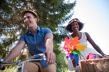 Image showing Young multiethnic couple having a bike ride in nature