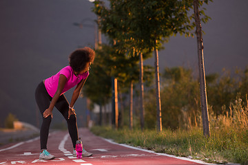 Image showing Portrait of a young african american woman running outdoors