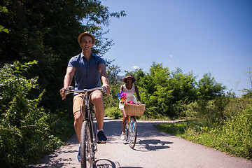 Image showing Young multiethnic couple having a bike ride in nature