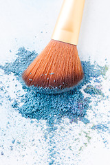 Image showing Blank background with crumbled eye shadows and brush