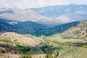 Image showing Views of hilly landscape with mountains and blue cloudy sky