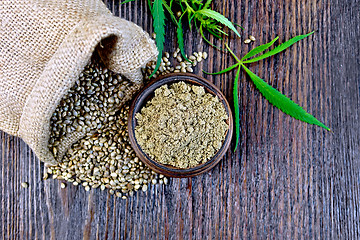 Image showing Flour hemp in bowl with grain and bag on board top