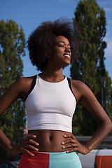 Image showing Portrait of sporty young african american woman running outdoors