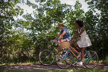 Image showing Young multiethnic couple having a bike ride in nature