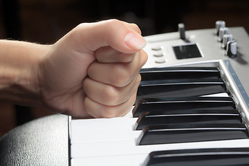 Image showing Girl\'s hands on the keyboard of the piano