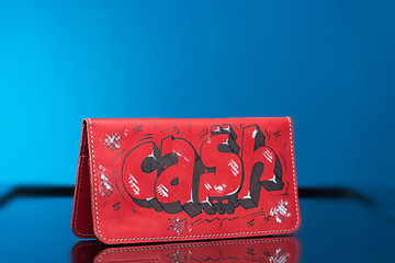Image showing red woman clutch bag. with the words cash