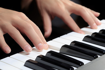 Image showing Girl\'s hands on the keyboard of the piano