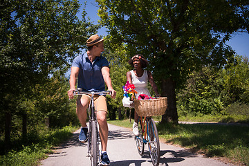 Image showing Young multiethnic couple having a bike ride in nature