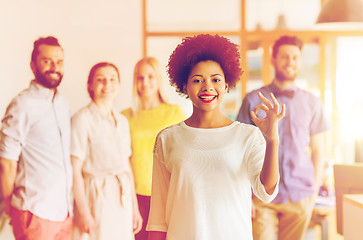 Image showing happy woman showing ok over creative office team