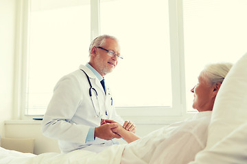 Image showing doctor checking senior woman pulse at hospital