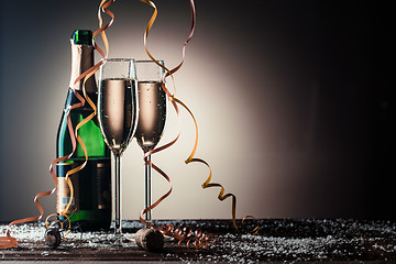 Image showing Open bottle of champagne and two filled glasses with snowflakes