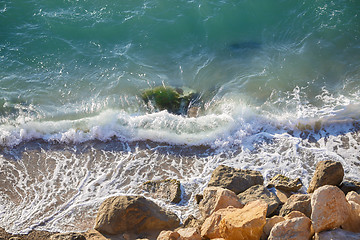 Image showing Large coastal rocks and soft waves. Nature on sunny day