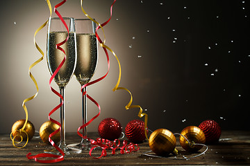 Image showing Champagne glasses, snowflakes, Christmas red and yellow ball with ribbons