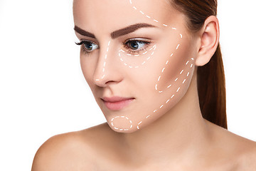 Image showing The beautiful woman face with arrows close up over white background