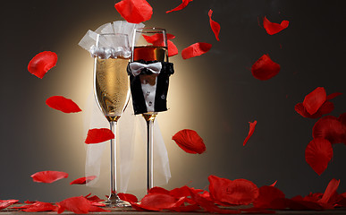Image showing Beautiful decorated champagne glasses for newlyweds with red rose petals