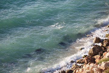 Image showing Waves lapping on large coastal rocks