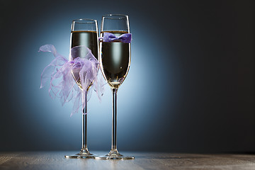 Image showing Champagne glasses decorated purple bow-tie and veil for honeymooners