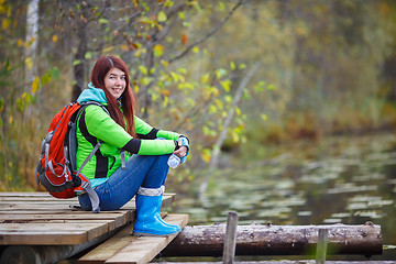 Image showing Young girl with long hair and backpack tourist