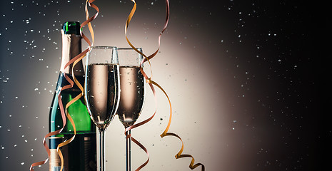 Image showing Bottle of champagne and two filled glasses, holiday concept