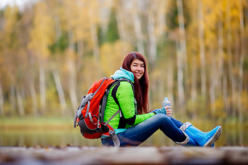 Image showing Long-haired brunette with backpack