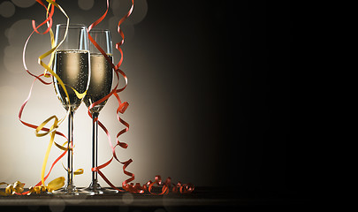 Image showing Two glasses with sparkling champagne and decorative ribbons