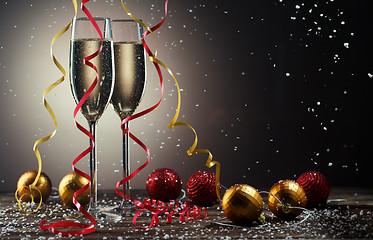 Image showing Glasses of sparkling champagne with Christmas decorations and snowflakes