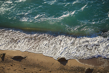 Image showing Soft waves and sea foam on sandy beach