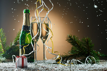 Image showing Festive Christmas composition with champagne glasses, gift and snow