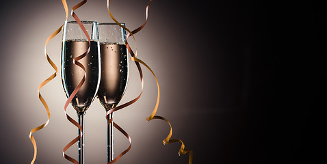 Image showing Two glasses filled with champagne ready to party