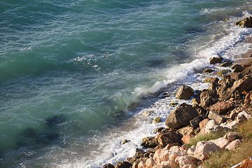 Image showing Wild beach with yellow stones and clear sea