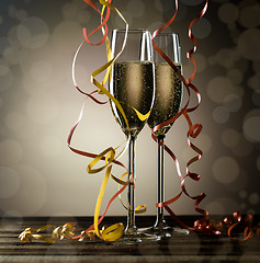 Image showing Sparkling champagne in glasses with festive serpentine