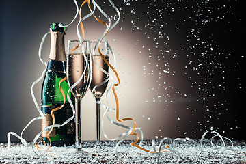 Image showing Bottle of champagne and wine glasses with ribbons