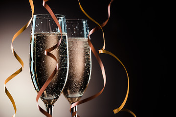 Image showing Two wineglasses with sparkling champagne and decorative ribbons