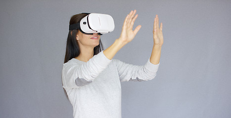 Image showing Adorable woman working with virtual reality glasses
