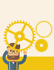 Image showing Businessman holding up gears