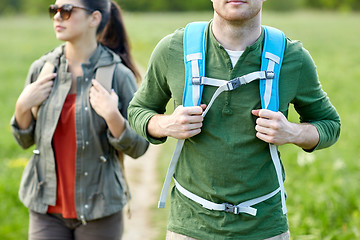 Image showing close up of couple with backpacks hiking outdoors