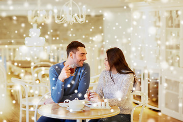 Image showing happy couple drinking tea at cafe