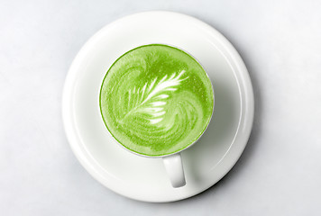 Image showing cup of matcha green tea latte over white