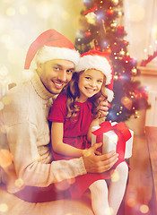 Image showing smiling father and daughter holding gift box