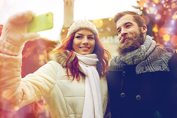 Image showing couple taking selfie with smartphone in old town