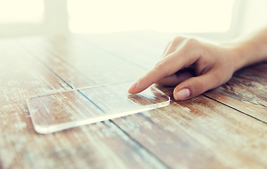 Image showing close up of woman with transparent smartphone