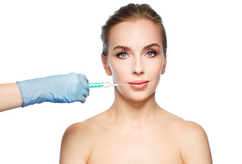 Image showing woman face and hand with syringe making injection