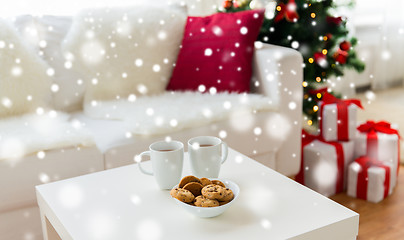 Image showing close up of christmas cookies and cups on table