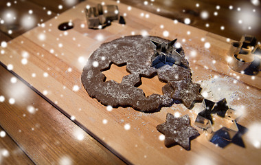 Image showing close up of ginger dough, molds and flour on board