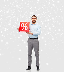 Image showing smiling man with red percentage sign over snow