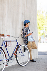 Image showing man with smartphone, earphones and bicycle