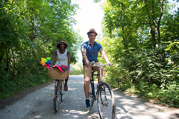 Image showing Young multiethnic couple having a bike ride in nature